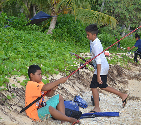 Kids getting ready to cast their fishing poles at the Tinian Youth Fishing Derby