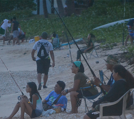 Youth and Families casting their fishing poles at Kammer Beach (Youth Fishing Derby)
